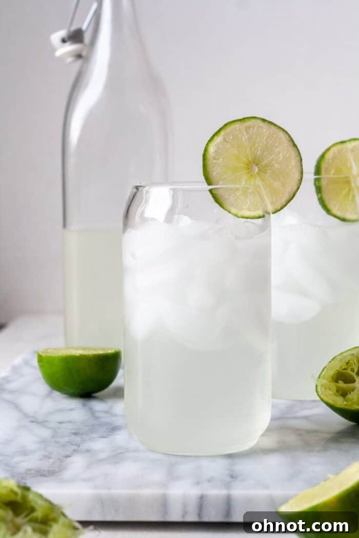 Lime juice in glass cups, garnished with fresh lime slices and ice.