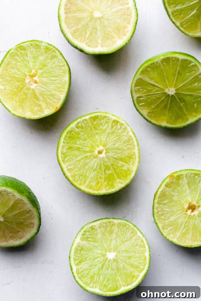 Freshly sliced limes and a juicer, ready for juice extraction.