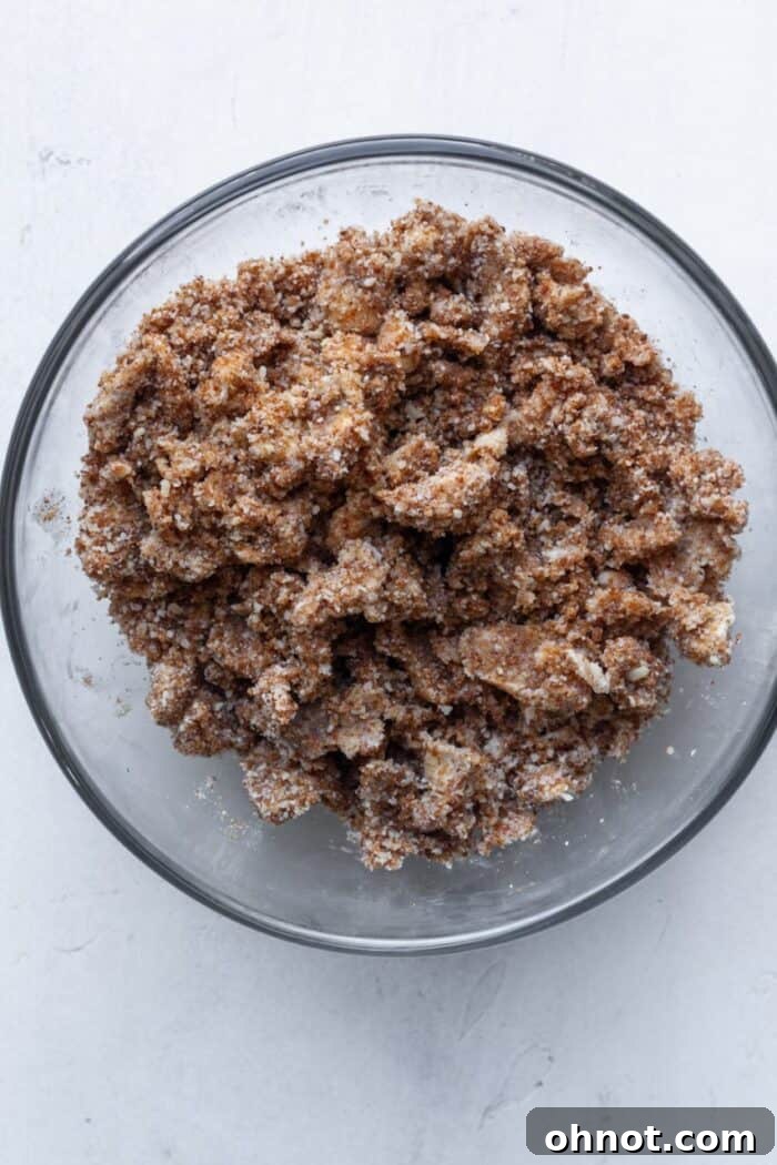 Cinnamon streusel topping with visible butter crumbs in a glass bowl.