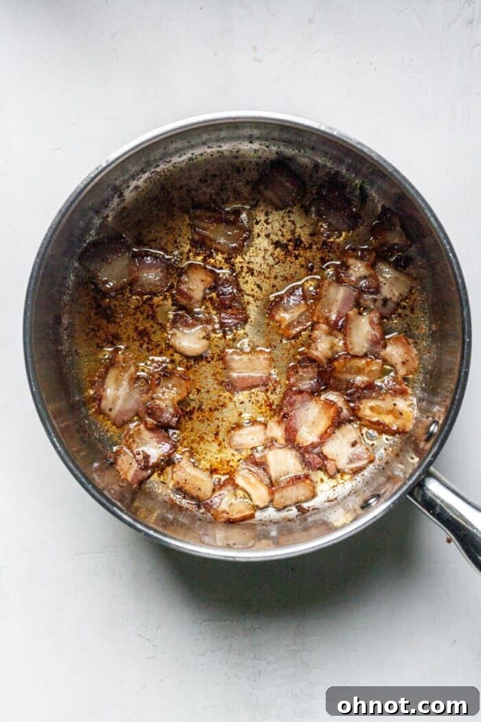 Crispy cooked bacon in a pot, showing golden brown pieces