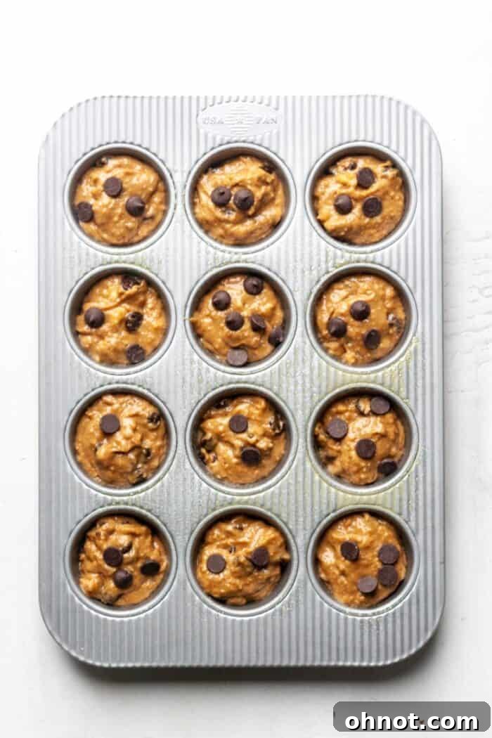 Muffin pan filled with banana protein muffin batter.