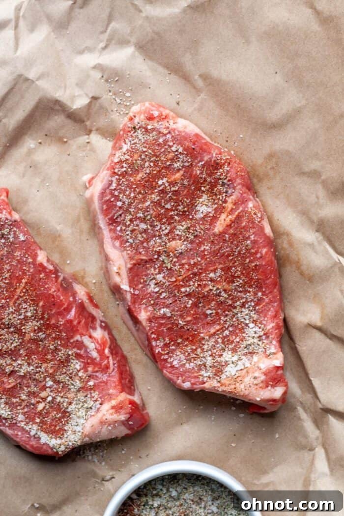 Seasoned sirloin steak on paper