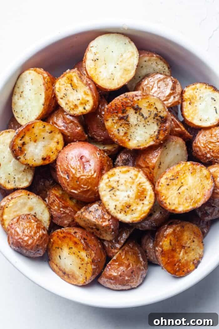 Crispy golden air fryer diced potatoes served in a white bowl, perfectly seasoned and ready to eat