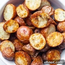 Crispy air fryer diced potatoes in white bowl