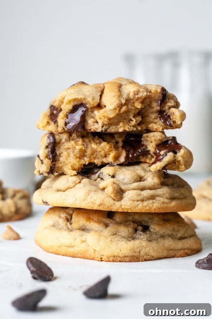 A stack of perfectly baked gluten-free peanut butter cookies with visible chocolate and peanut butter chips.