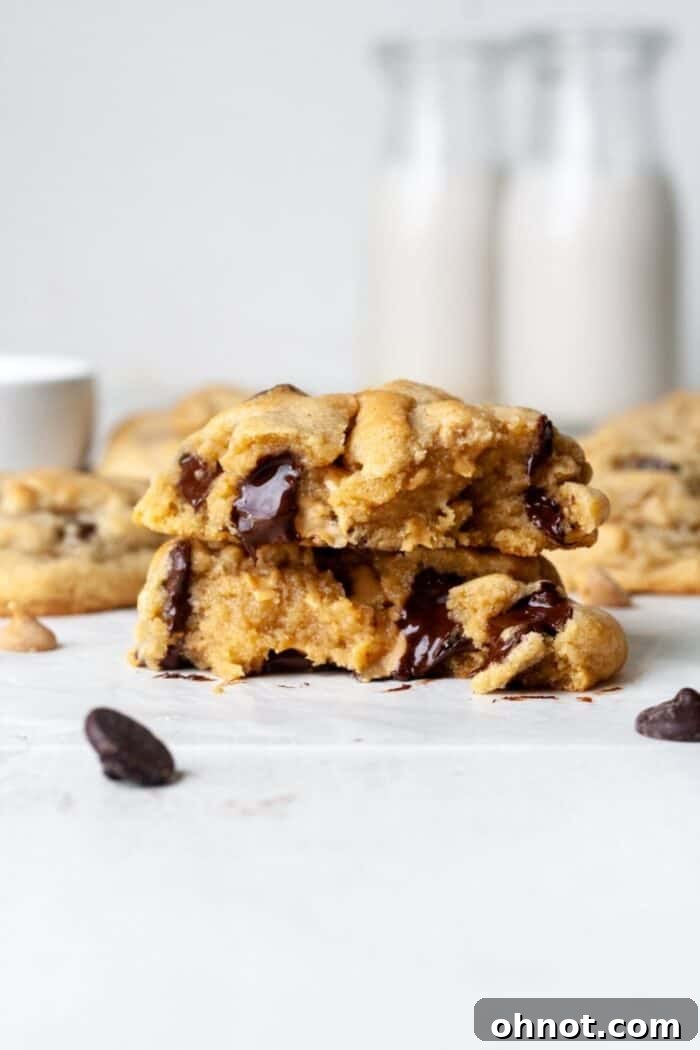 A close-up of a warm, gooey gluten-free peanut butter cookie, revealing its soft center.