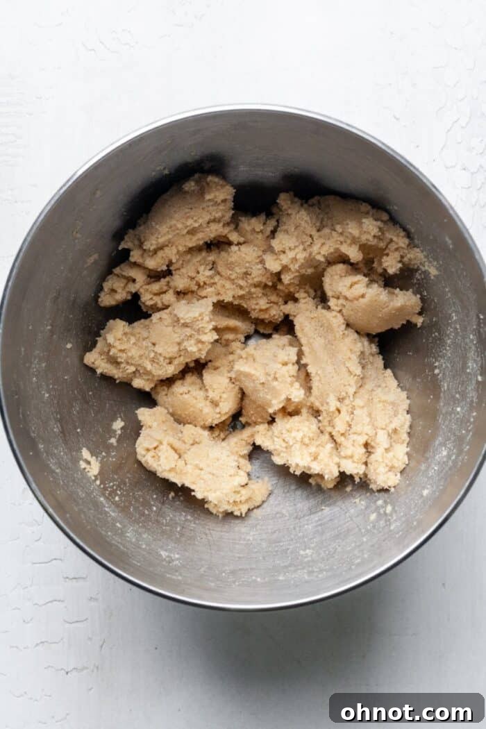 Creamed butter and sugar mixture, light and fluffy, in a mixing bowl.
