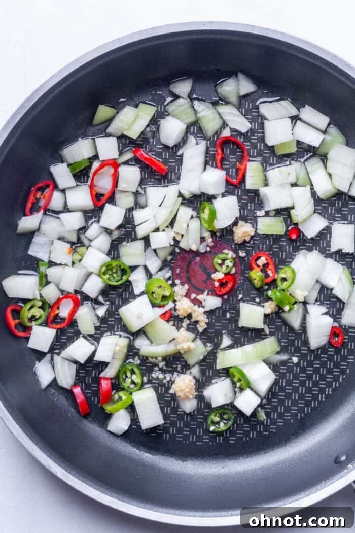 Diced onions and chili peppers in pan
