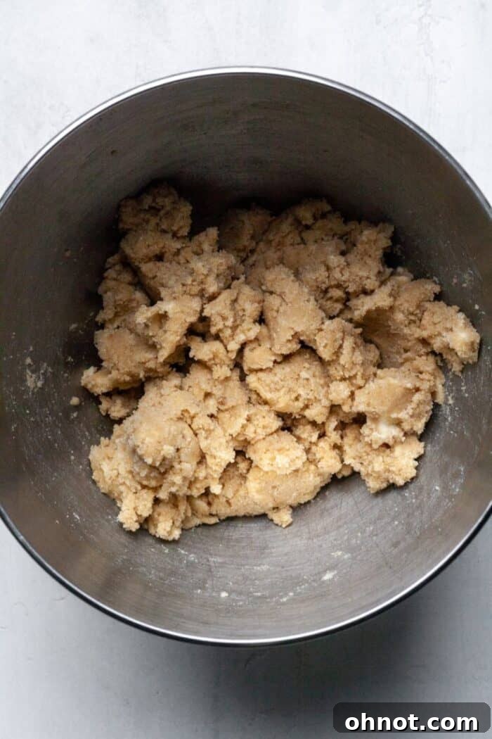The butter and sugars creamed together in a bowl, appearing light and fluffy.