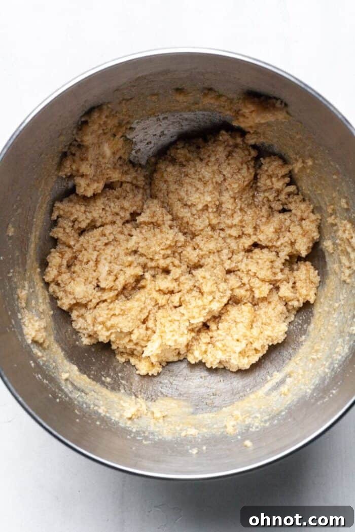 All wet ingredients mixed thoroughly in the bowl, creating a smooth base for the cookie dough.