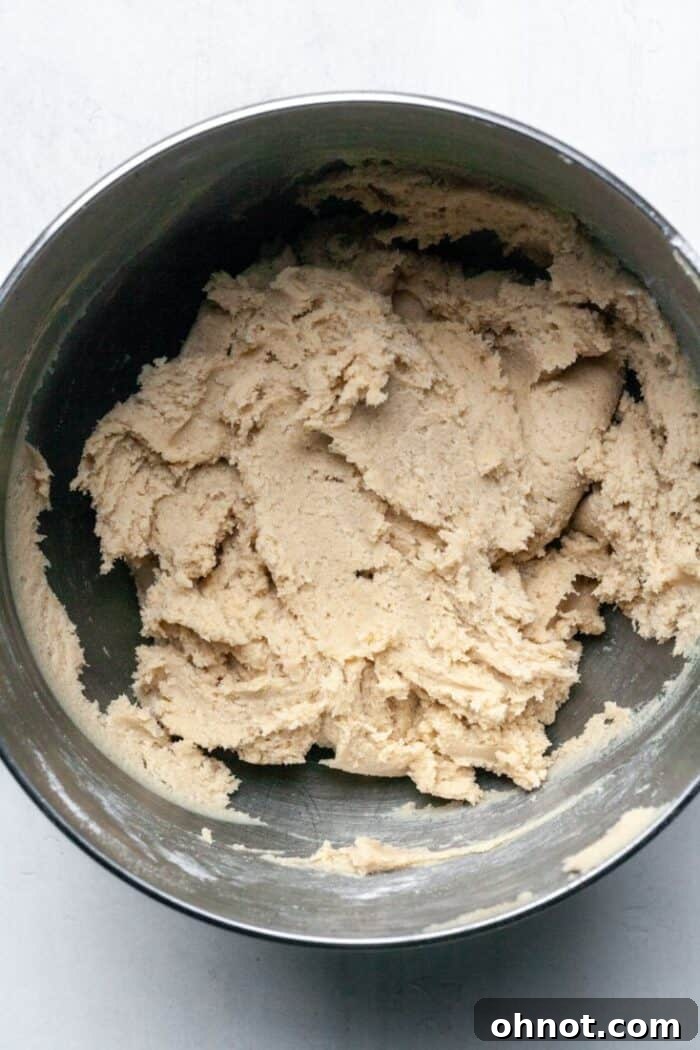 A bowl of thick cookie dough, ready for the chocolate chips.