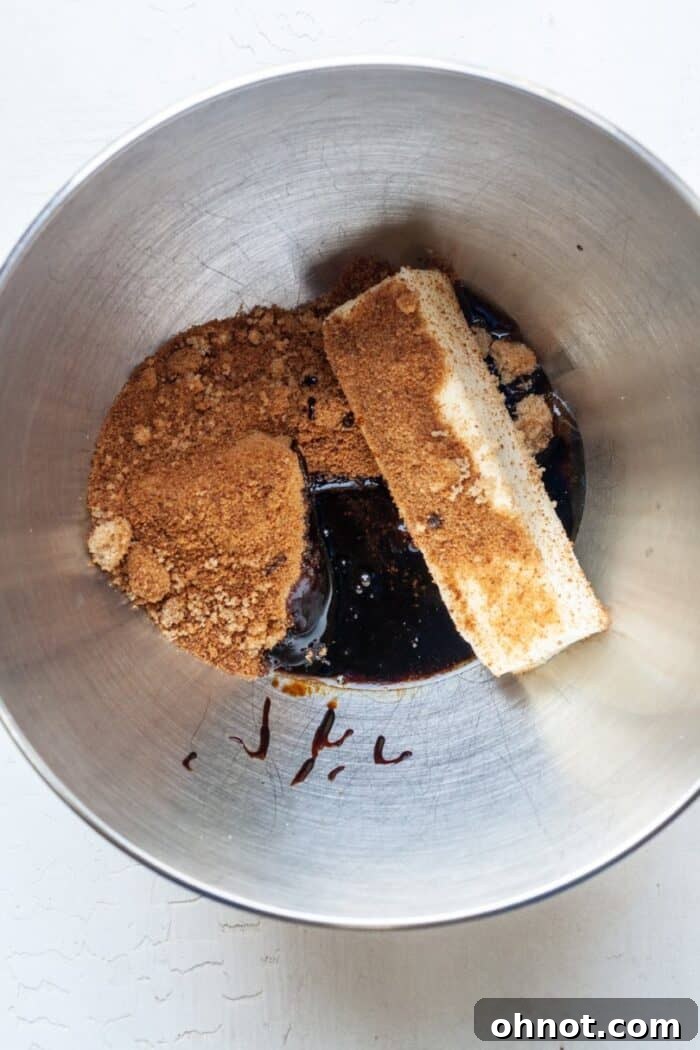 Creaming Vegan butter and molasses in a mixing bowl.