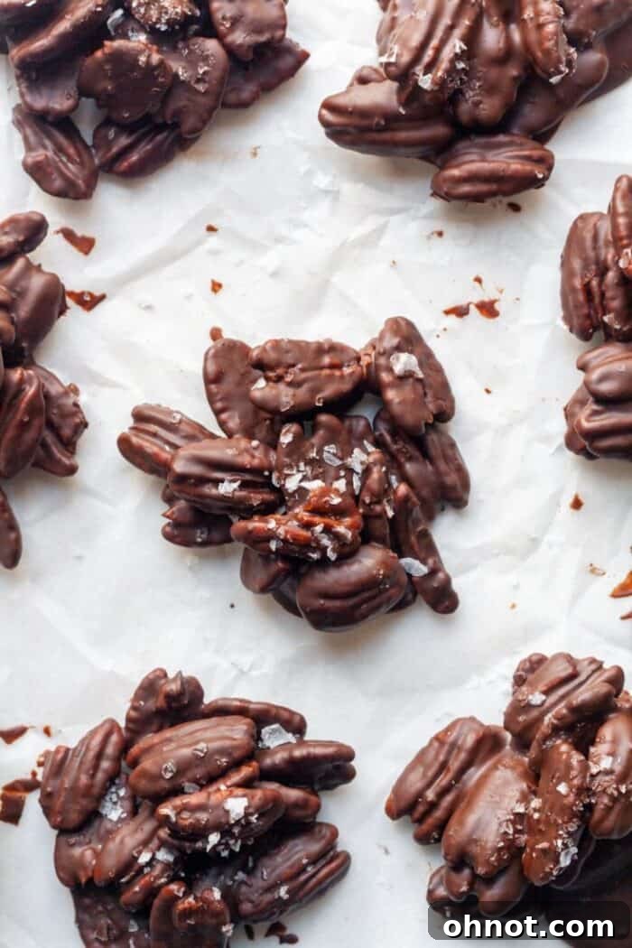 Chocolate covered pecans on parchment paper