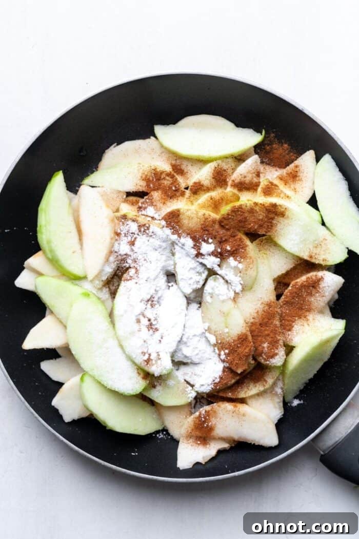 Apples and cinnamon gently cooking in a skillet