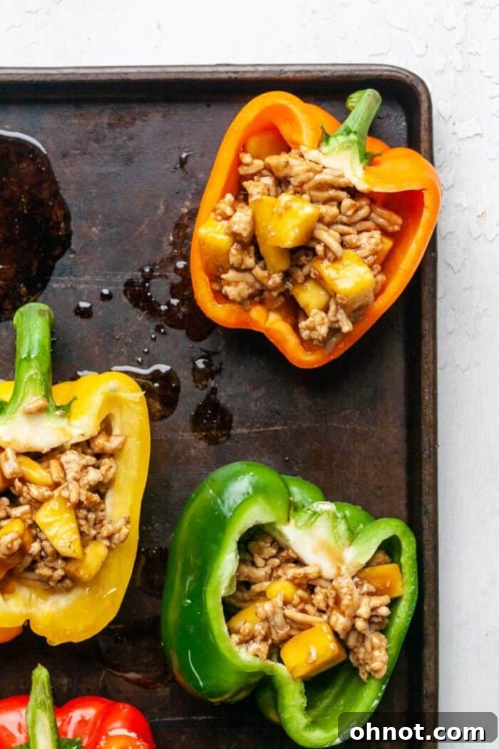 Bell peppers generously stuffed with the chicken and pineapple filling.