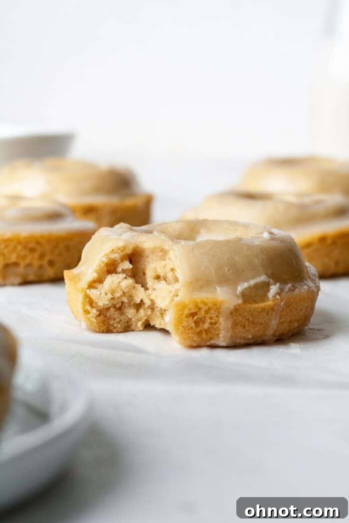 Healthy baked gluten-free donuts arranged neatly on parchment paper, showcasing their delicate texture.