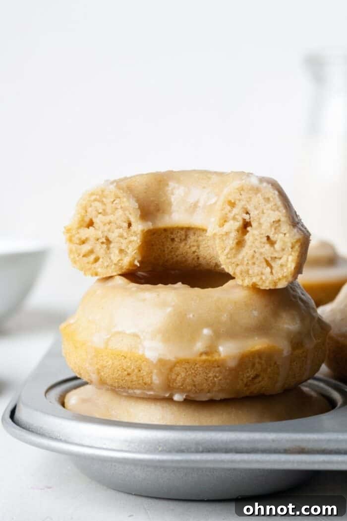 Baked gluten-free donuts cooling in their donut pan, showcasing their perfect shape.