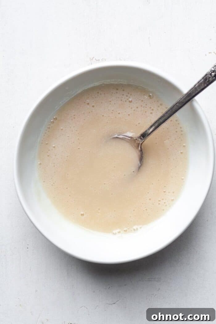 A bowl of creamy, smooth vanilla glaze, perfectly mixed and ready for dipping.