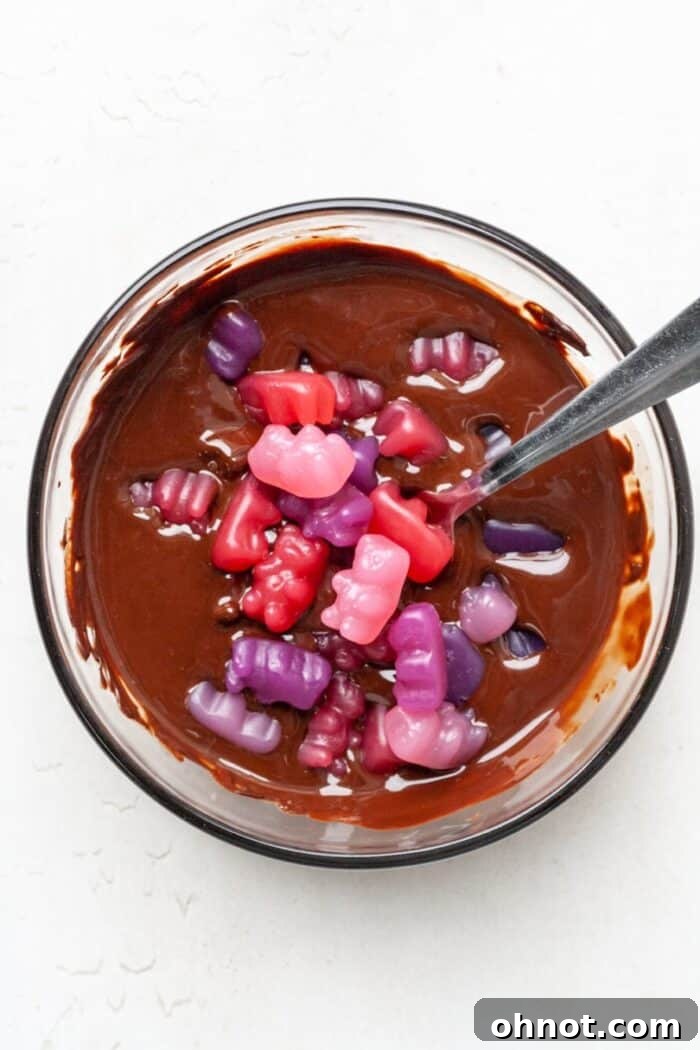 Gummy bears in melted chocolate bowl
