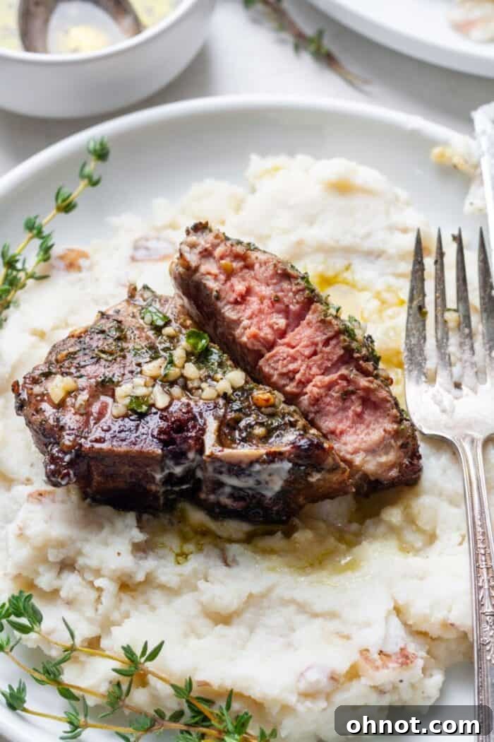 Plated air fryer lamb chops with mashed potatoes and fresh herbs