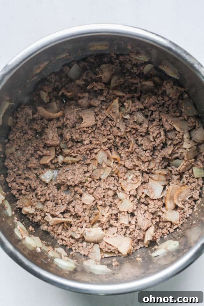 Ground beef and onions in pot