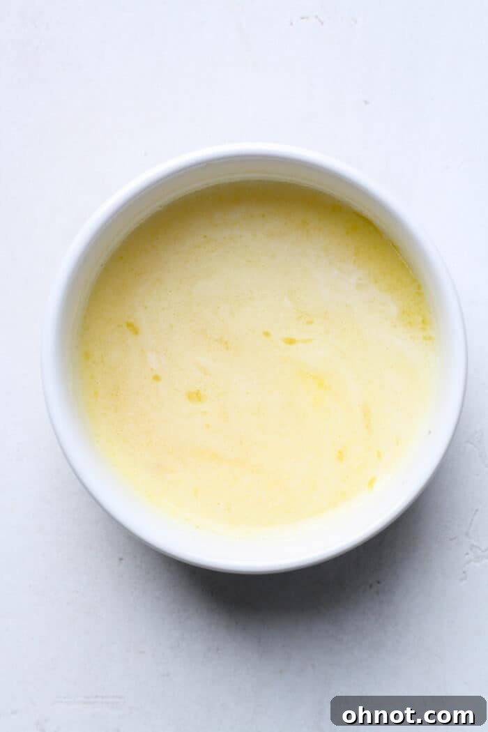 A small bowl of freshly made garlic butter sauce, ready for dipping.