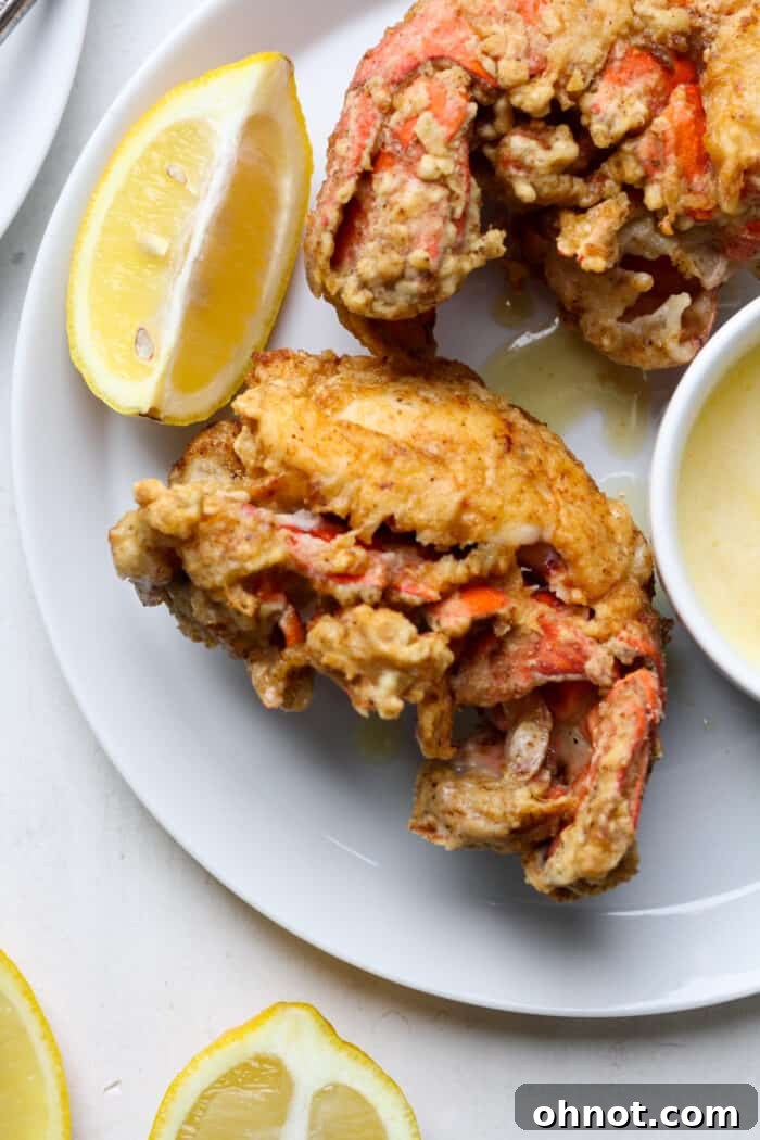 Close-up of golden-brown fried lobster tails, hot and ready to serve.