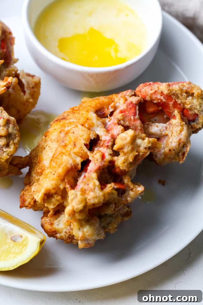 Close-up of a fried lobster tail showing the crispy breading and visible lobster meat.