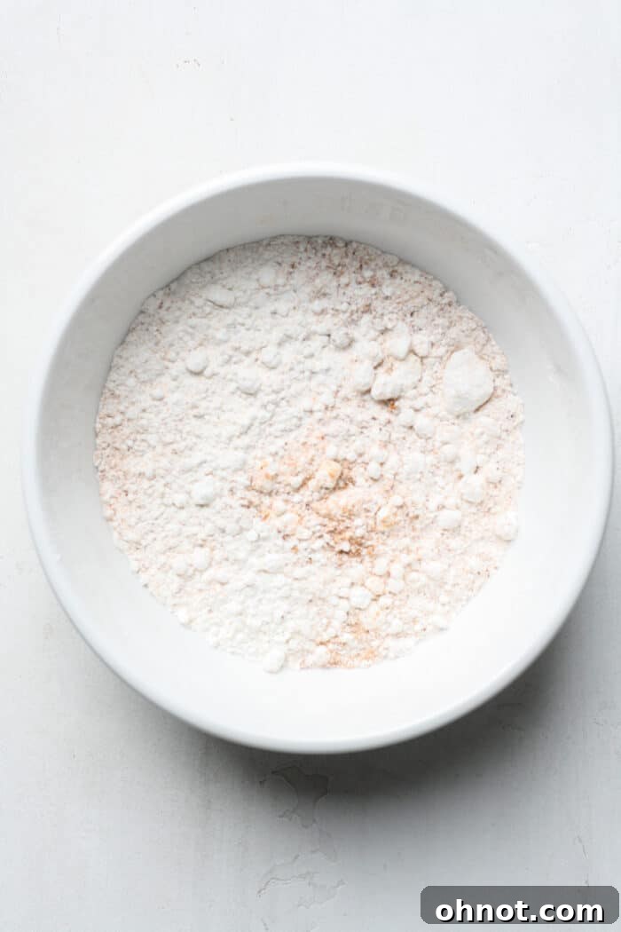 A bowl with flour and Old Bay seasoning, mixed and ready for coating.