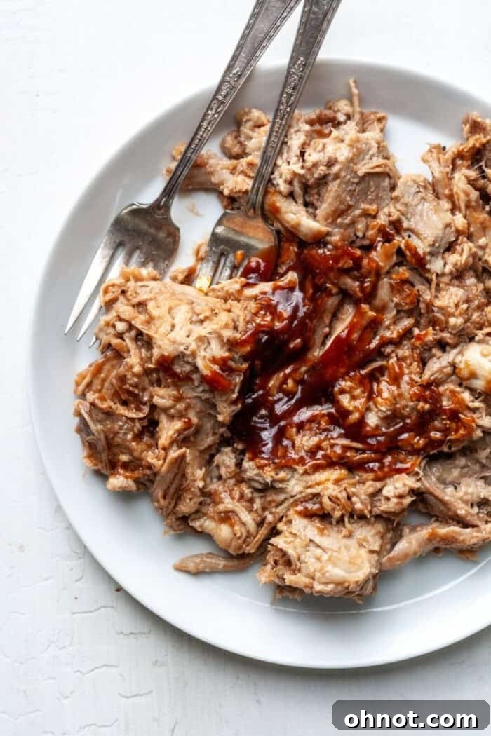 Whole30 Paleo Pulled Pork served on a white plate with green sides