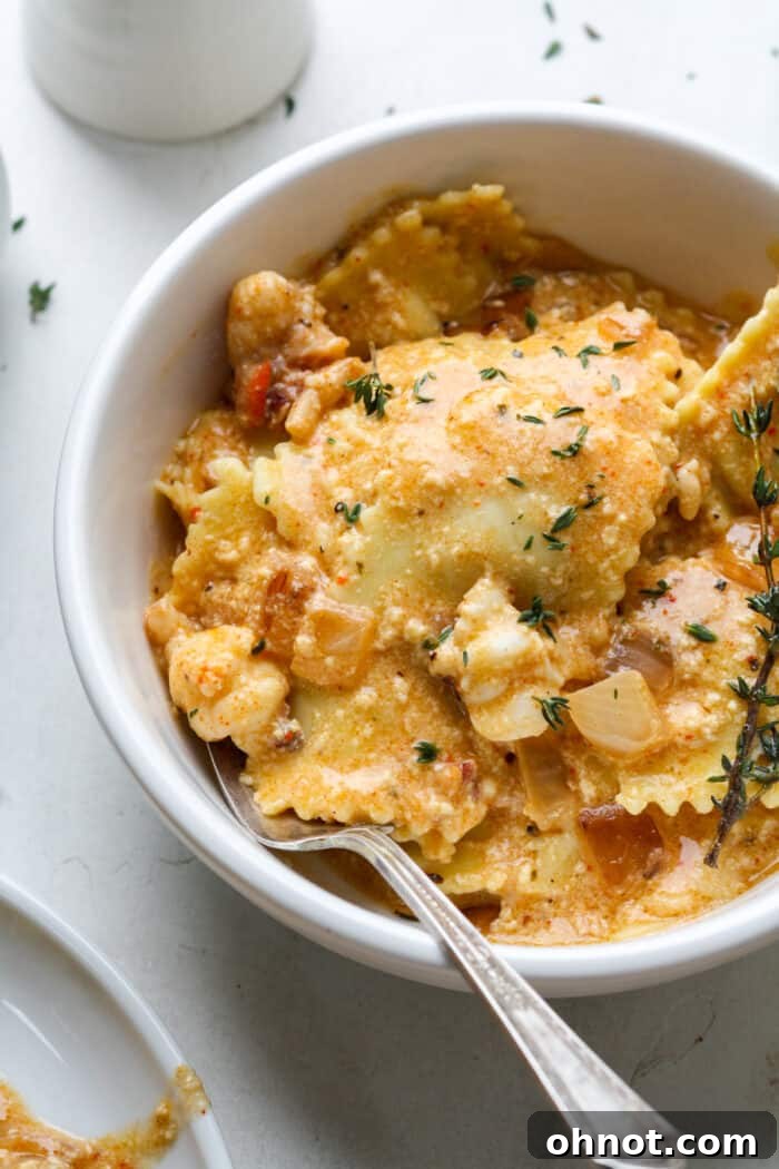 Close-up of creamy lobster sauce coating tender ravioli on a plate.
