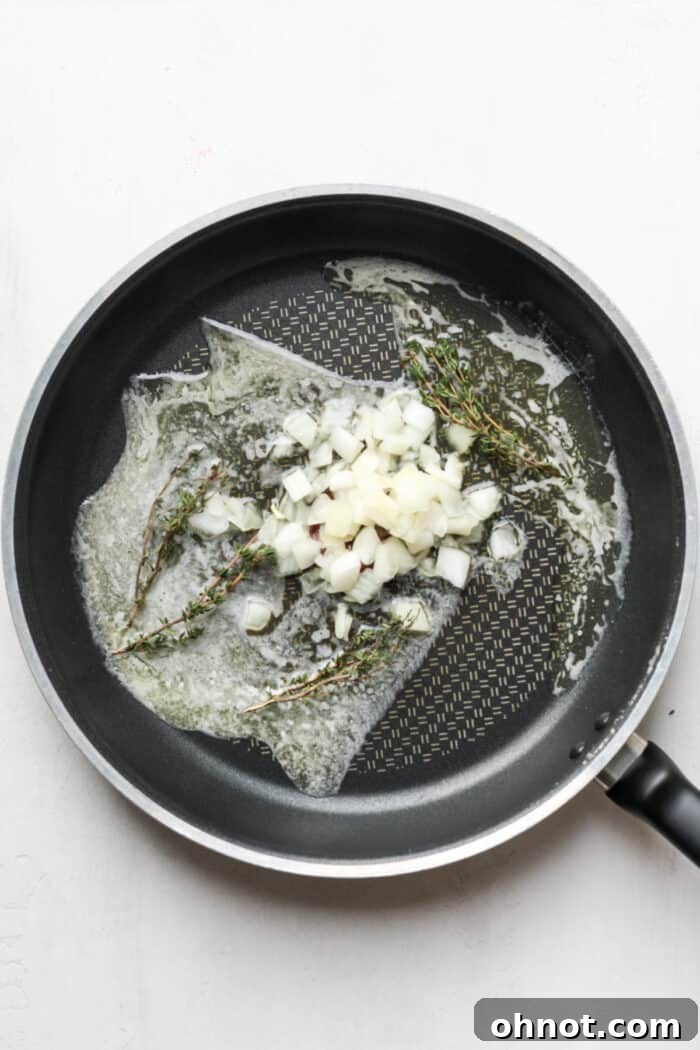 Butter and fresh thyme sizzling in a skillet.