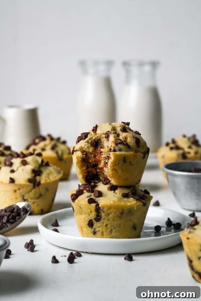 Stack of vegan chocolate chip muffins with almond milk in the background.