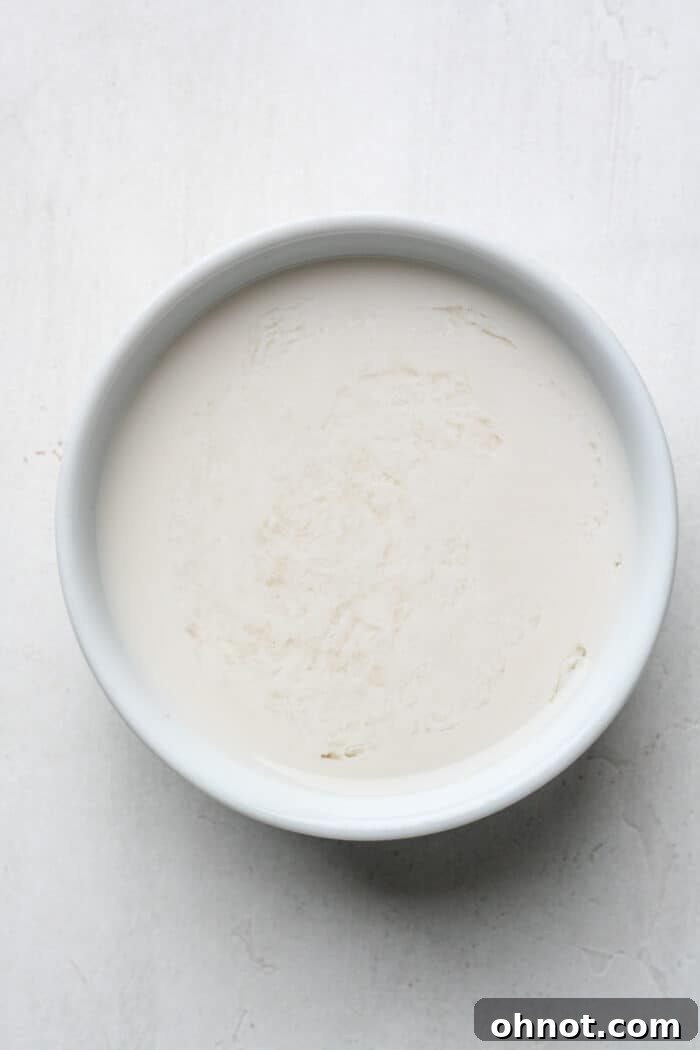 Almond milk poured into a small white bowl.