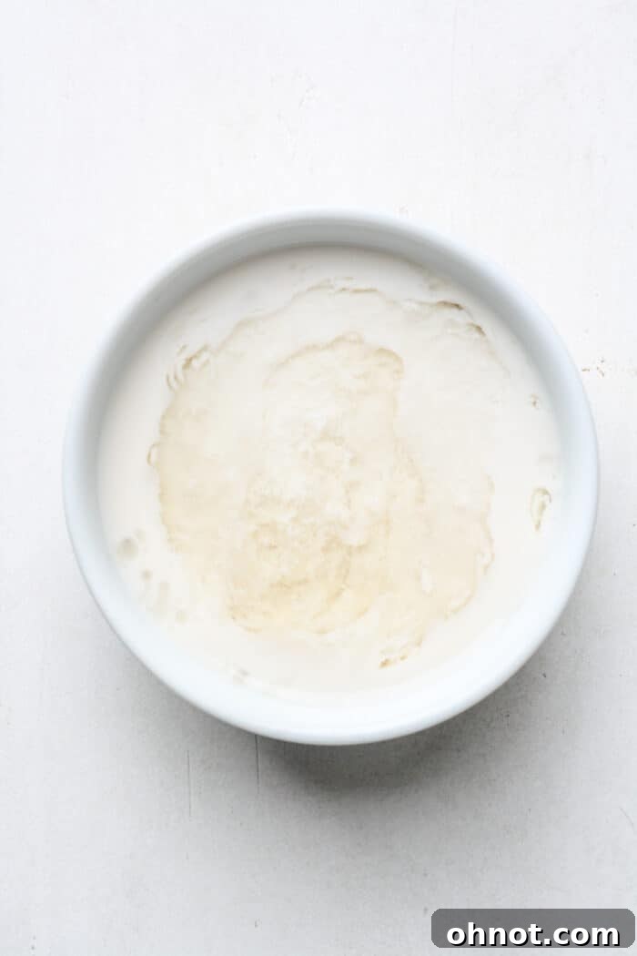 Almond milk and apple cider vinegar mixture, showing the initial curdling process.