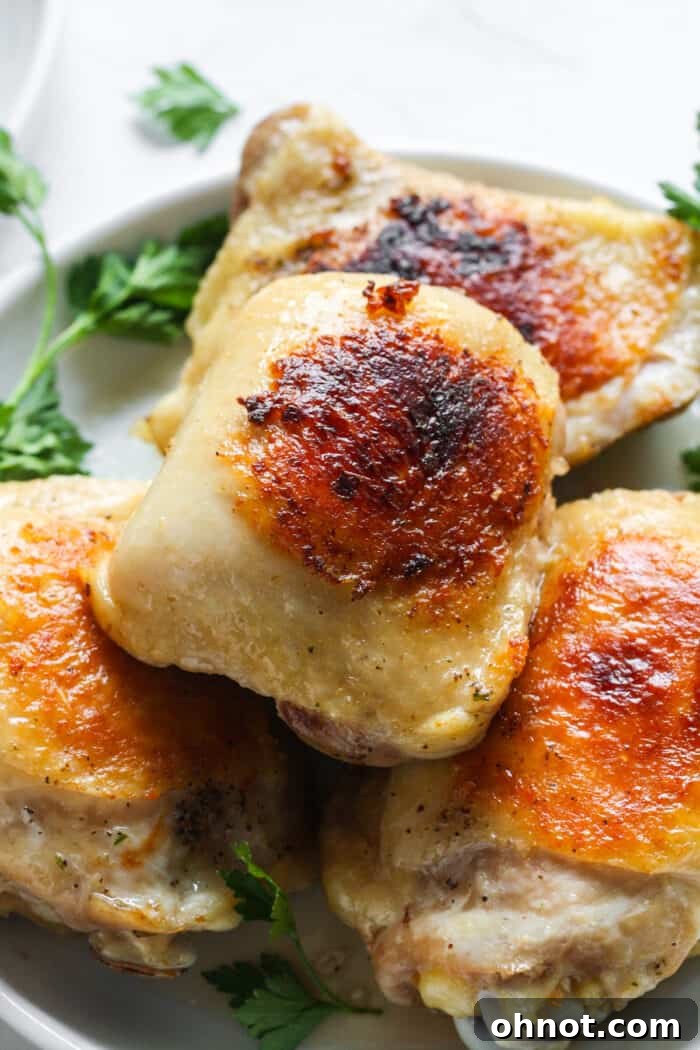 Plate with a sous vide chicken thigh, sliced to show its tender interior