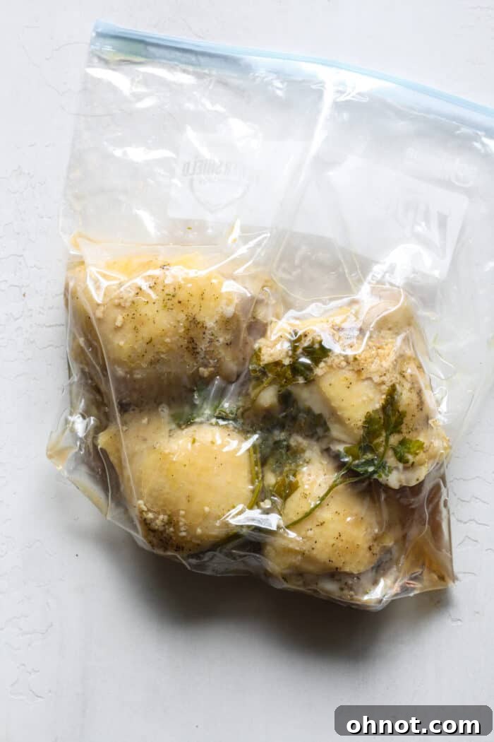 Clear plastic bag with chicken thighs cooking in a sous vide water bath