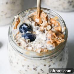 Jar of protein overnight oats with blueberries and peanut butter