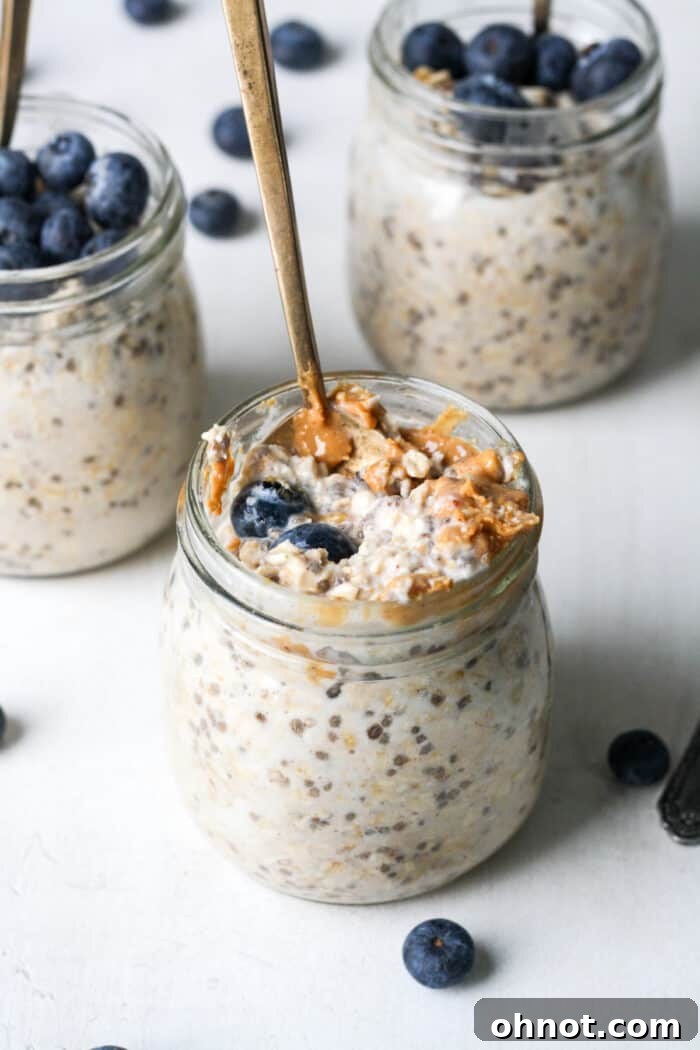 Jars of oatmeal with peanut butter and blueberries