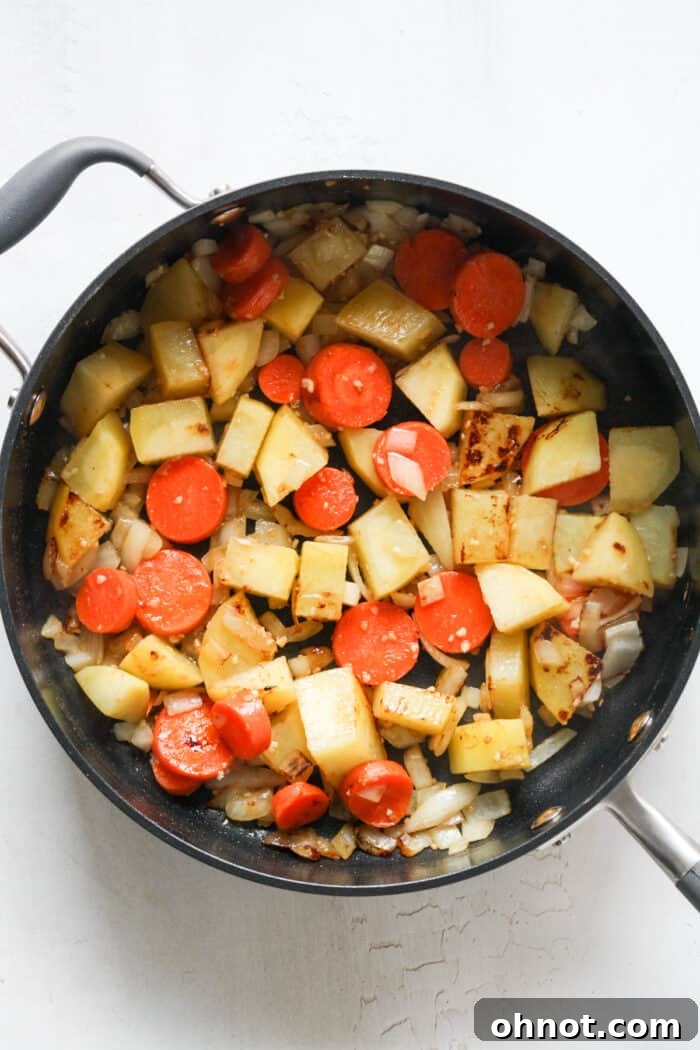 Softened and fragrant chopped vegetables cooking in a skillet, ready for the next step.