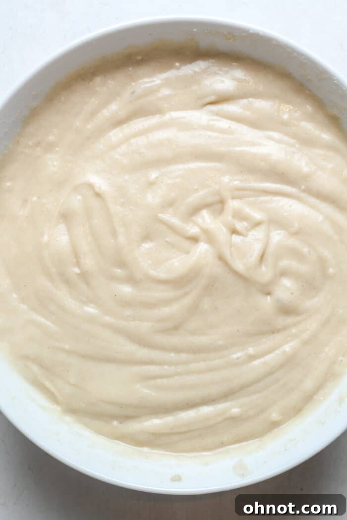 Vegan muffin batter in a bowl, showing the wet and dry ingredients just combined.