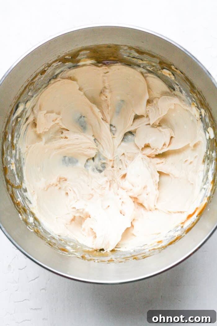 A bowl of fully softened cream cheese, showcasing its smooth texture, ready to be transformed into a delectable dip.