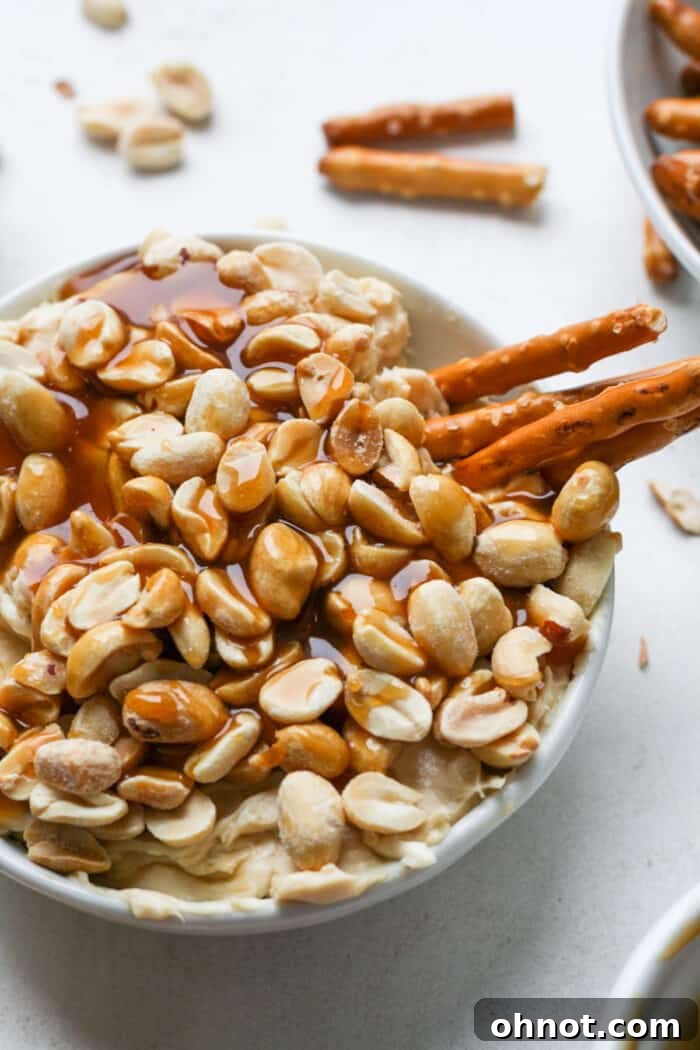 A handful of crisp pretzels, perfectly coated in the rich, creamy caramel dip, ready to be enjoyed as a delightful sweet and salty snack.