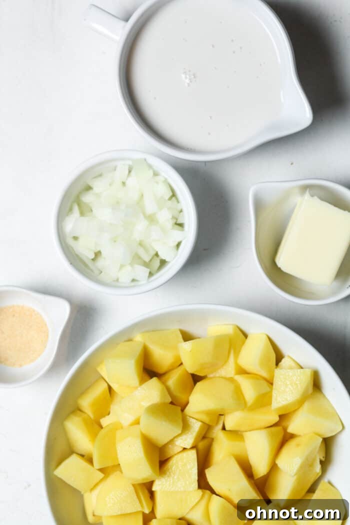 Freshly diced onions and perfectly cubed Russet potatoes, neatly arranged in separate bowls, ready for the soup preparation.