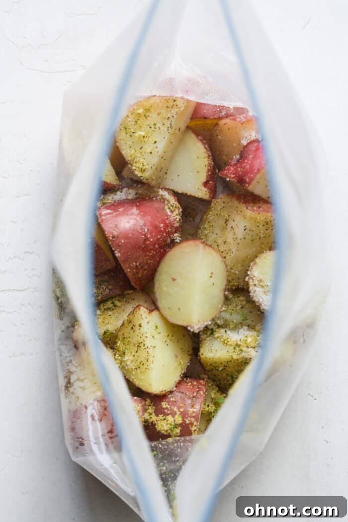 Potatoes and seasonings in a zippered bag before sealing