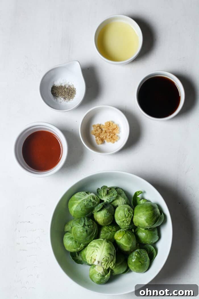 Brussels sprouts with coconut aminos, sriracha, and other ingredients in a bowl