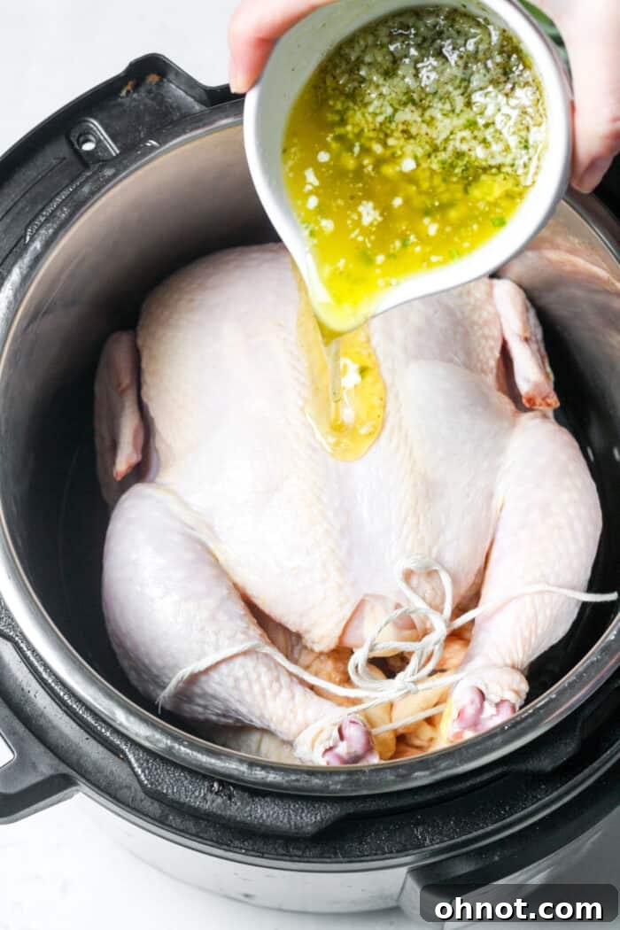 Melted butter being poured over chicken