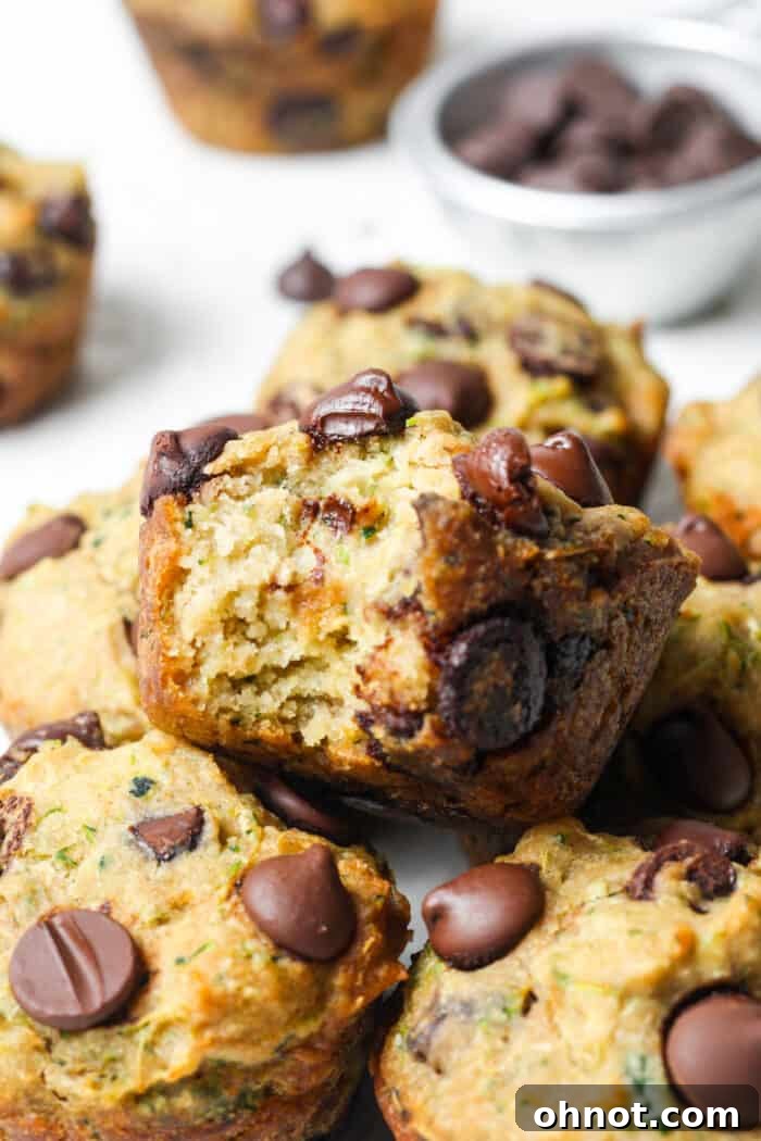 A batch of freshly baked vegan zucchini muffins, highlighting their fluffy interior and healthy ingredients.