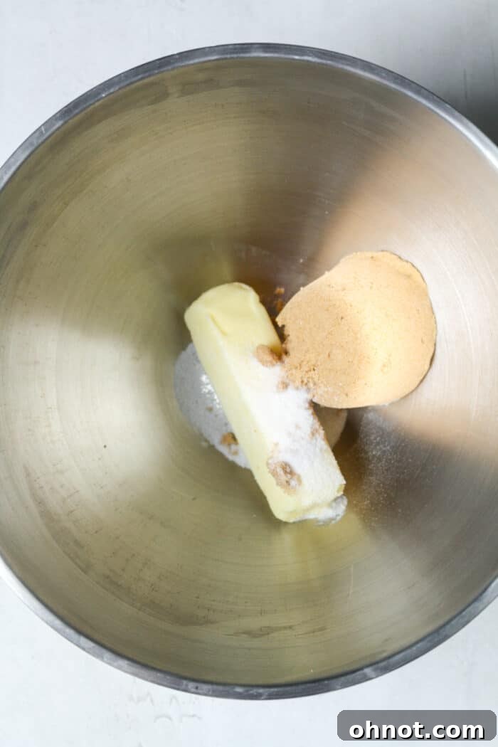 Room temperature butter, brown sugar, and granulated sugar in a mixing bowl.