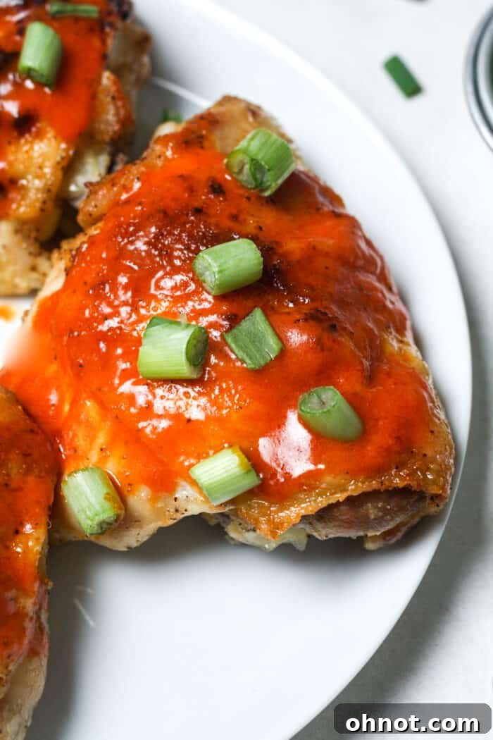 A close-up shot of buffalo hot sauce and butter melting in a white pan, highlighting the creamy texture.